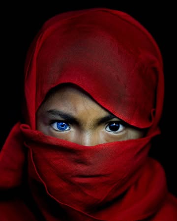 A small indigenous tribe in Southeast Asia, likely from Indonesia or the surrounding regions, where some members have strikingly bright blue eyes—a rare trait in people with darker skin tones. Scienti...