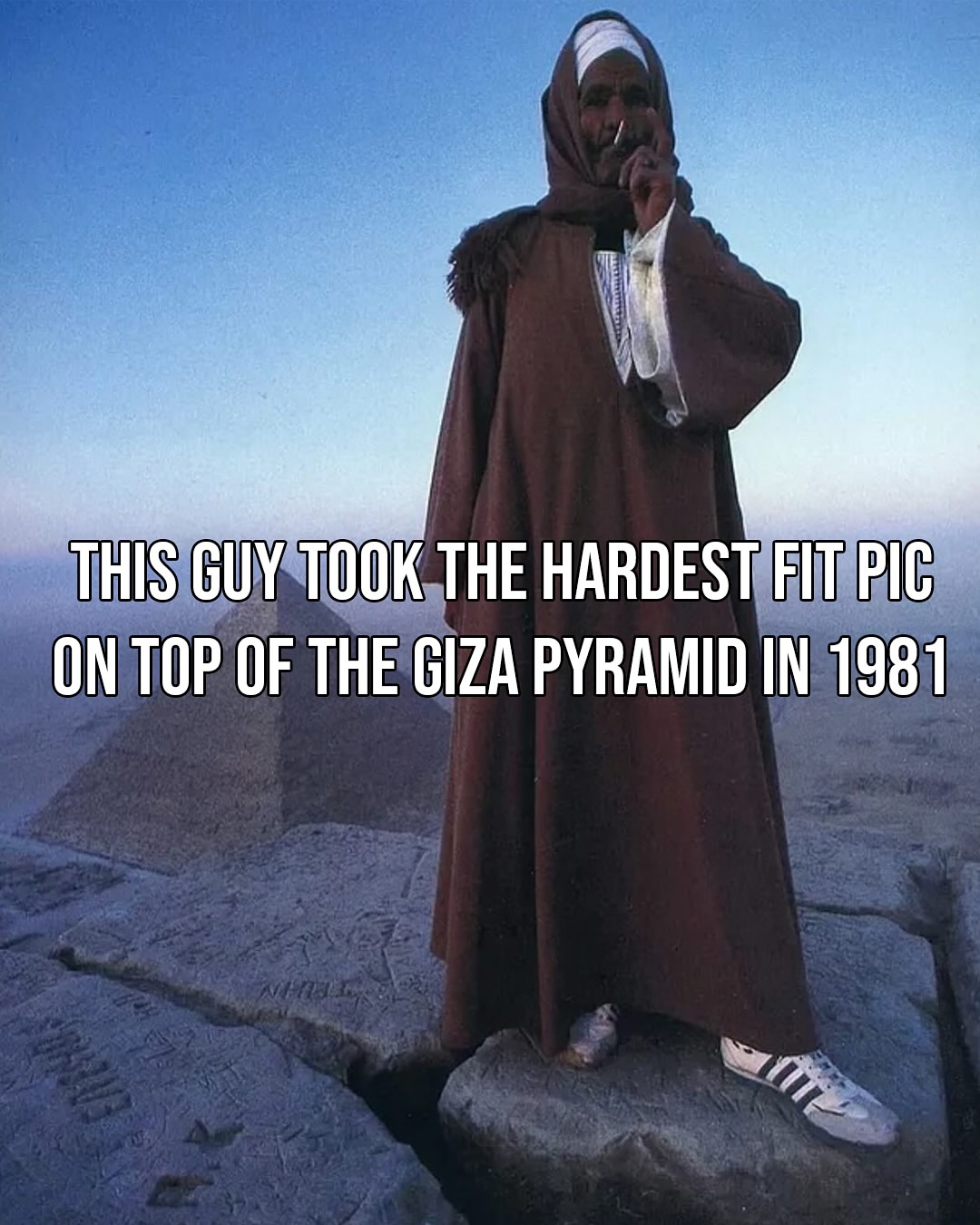 This 1981 photo captures an Egyptian man smoking a cigarette while standing atop the Great Pyramid of Giza.