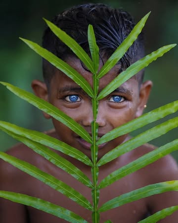 A small indigenous tribe in Southeast Asia, likely from Indonesia or the surrounding regions, where some members have strikingly bright blue eyes—a rare trait in people with darker skin tones. Scienti...
